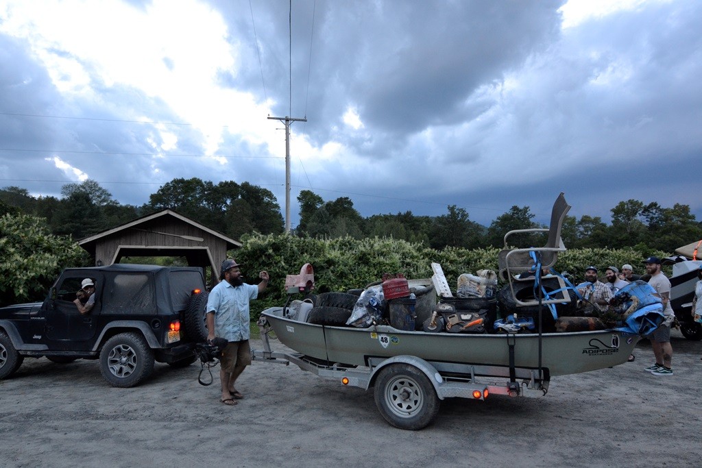 A drift boat bringing in a load of trash from a day cleaning the river.